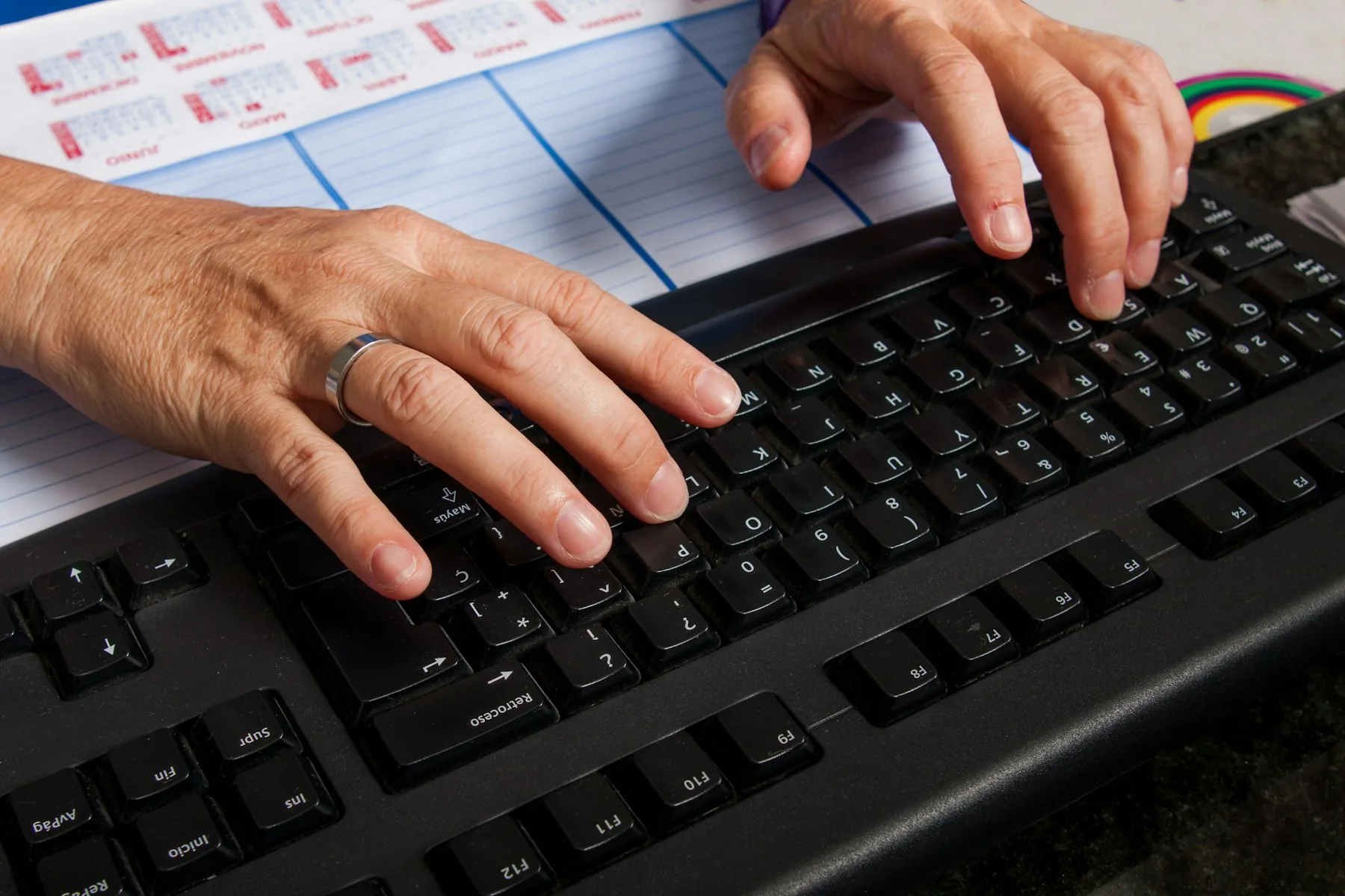 Hands working at a computer keyboard