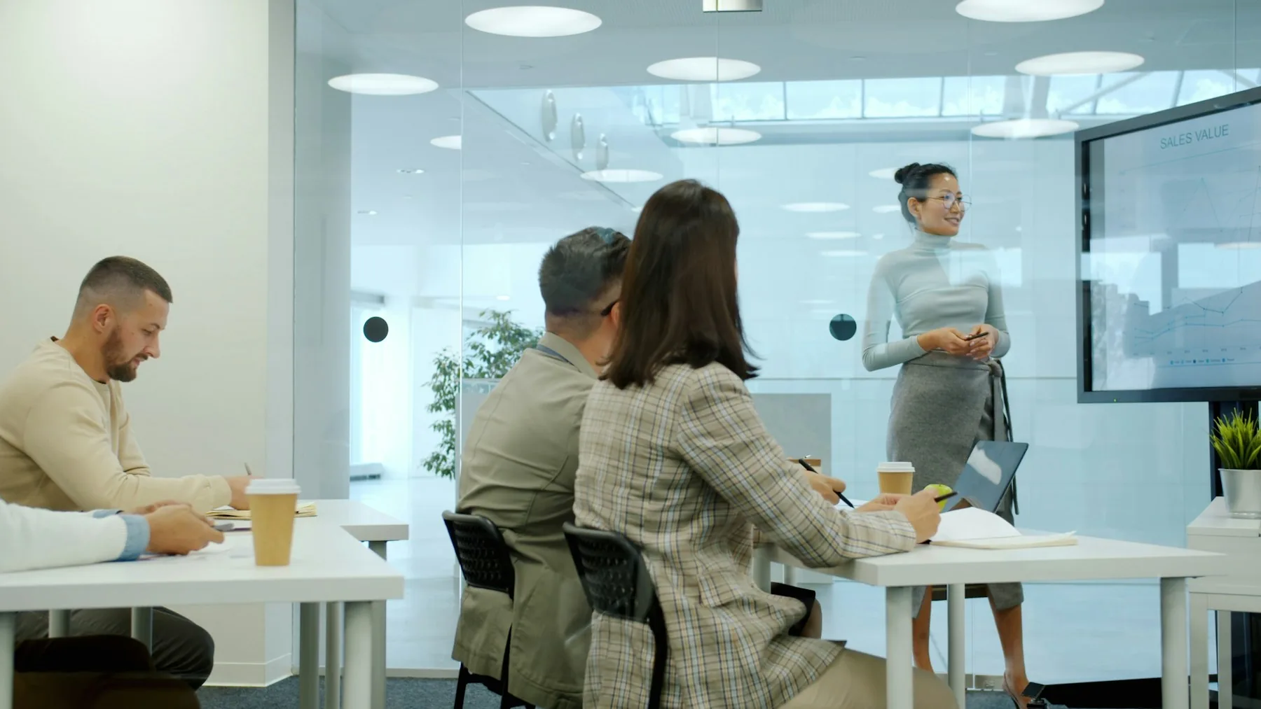 A presenter and colleagues considering information together in a meeting